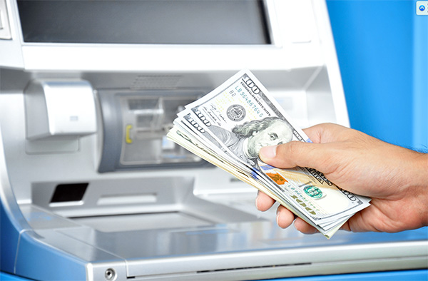 Man taking money out of an ATM machine